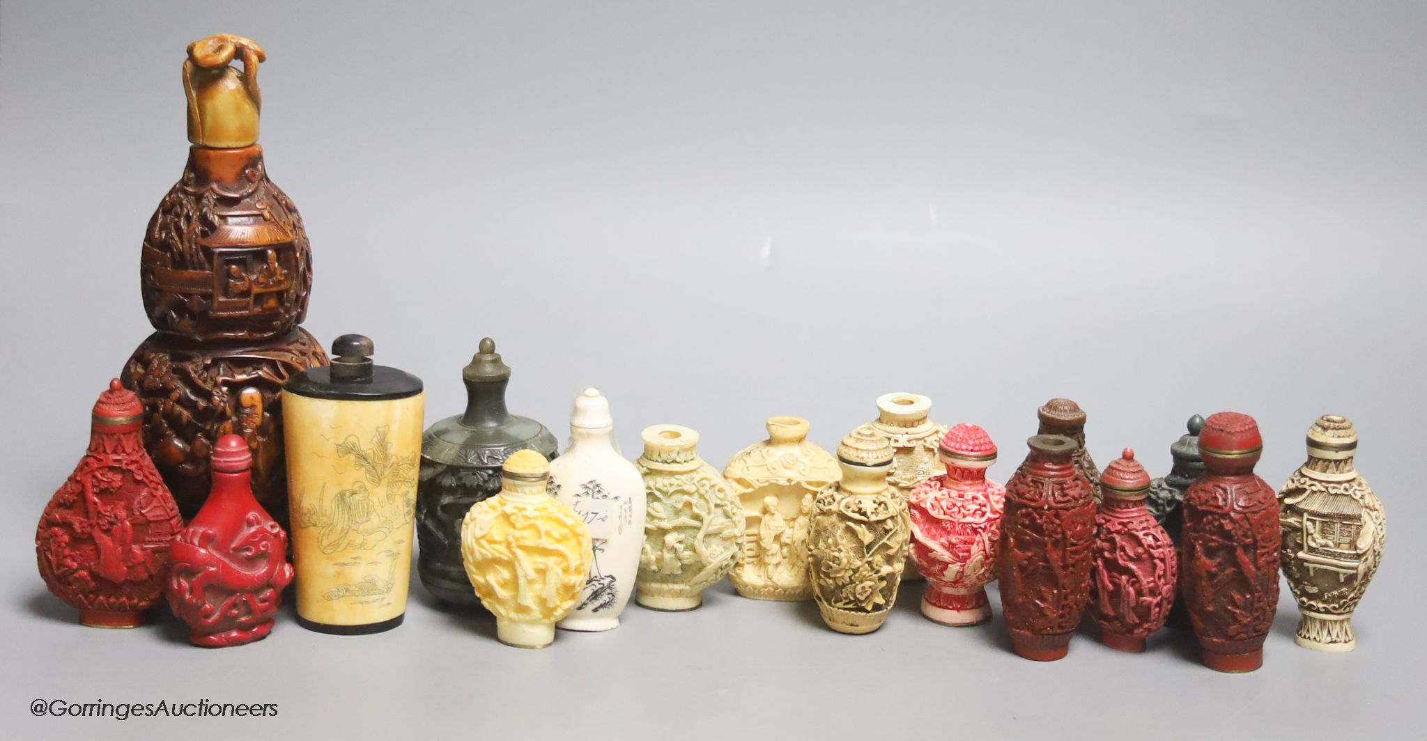 A large Chinese 20th century carved snuff bottle and smaller snuff bottles